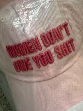 Pink “women don’t owe you shit” hat